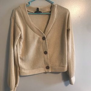 Cream colored cardigan with large buttons